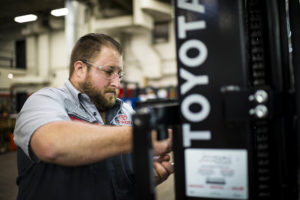 A Toyota Material Handling Solutions employee providing forklift maitenance