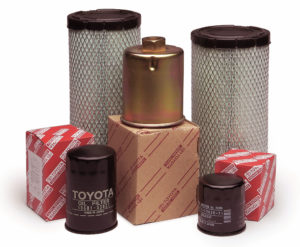 Studio image of forklift engine parts including spark plugs, air filters, fuel injectors, and water pumps.