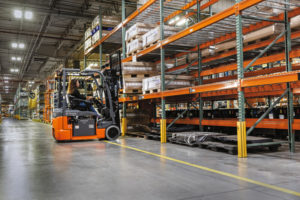 Toyota forklift lifting a pallet in a warehouse