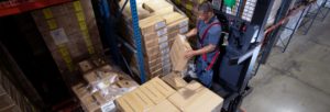Forklift operator picking boxes for an order