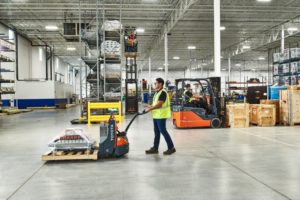 Toyota forklifts and pallet jacks working in a warehouse