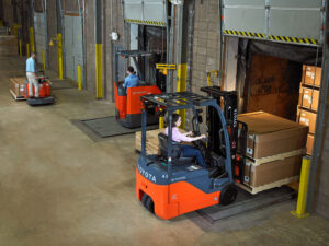 Toyota electric forklifts in a warehouse.