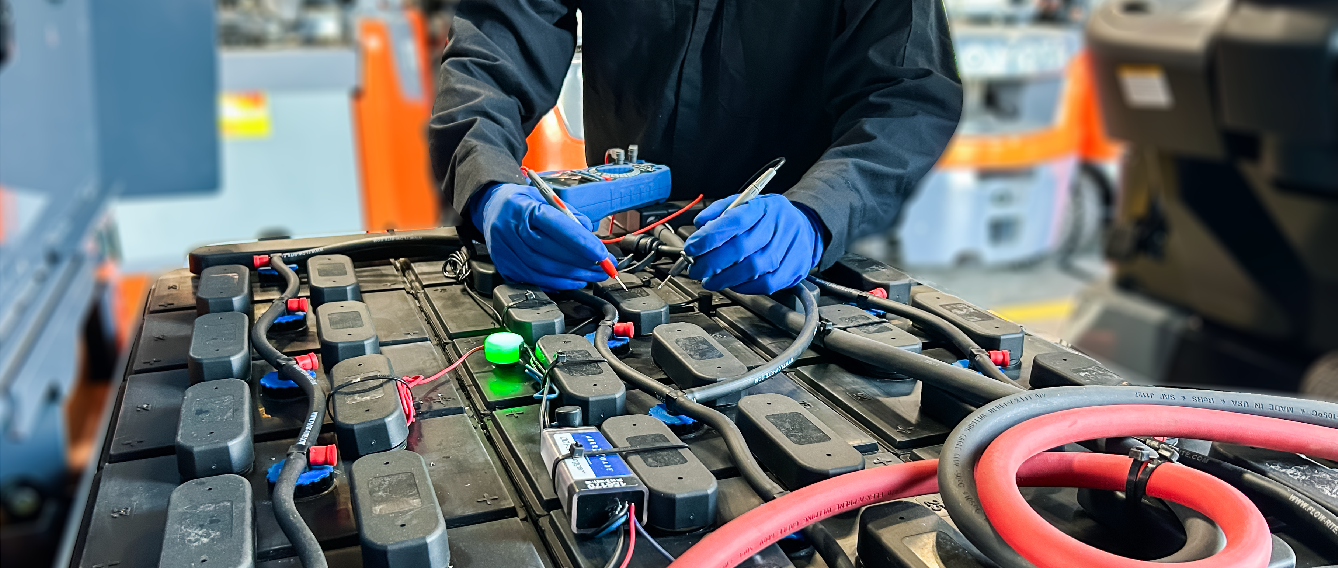 Technician works on a forklift battery